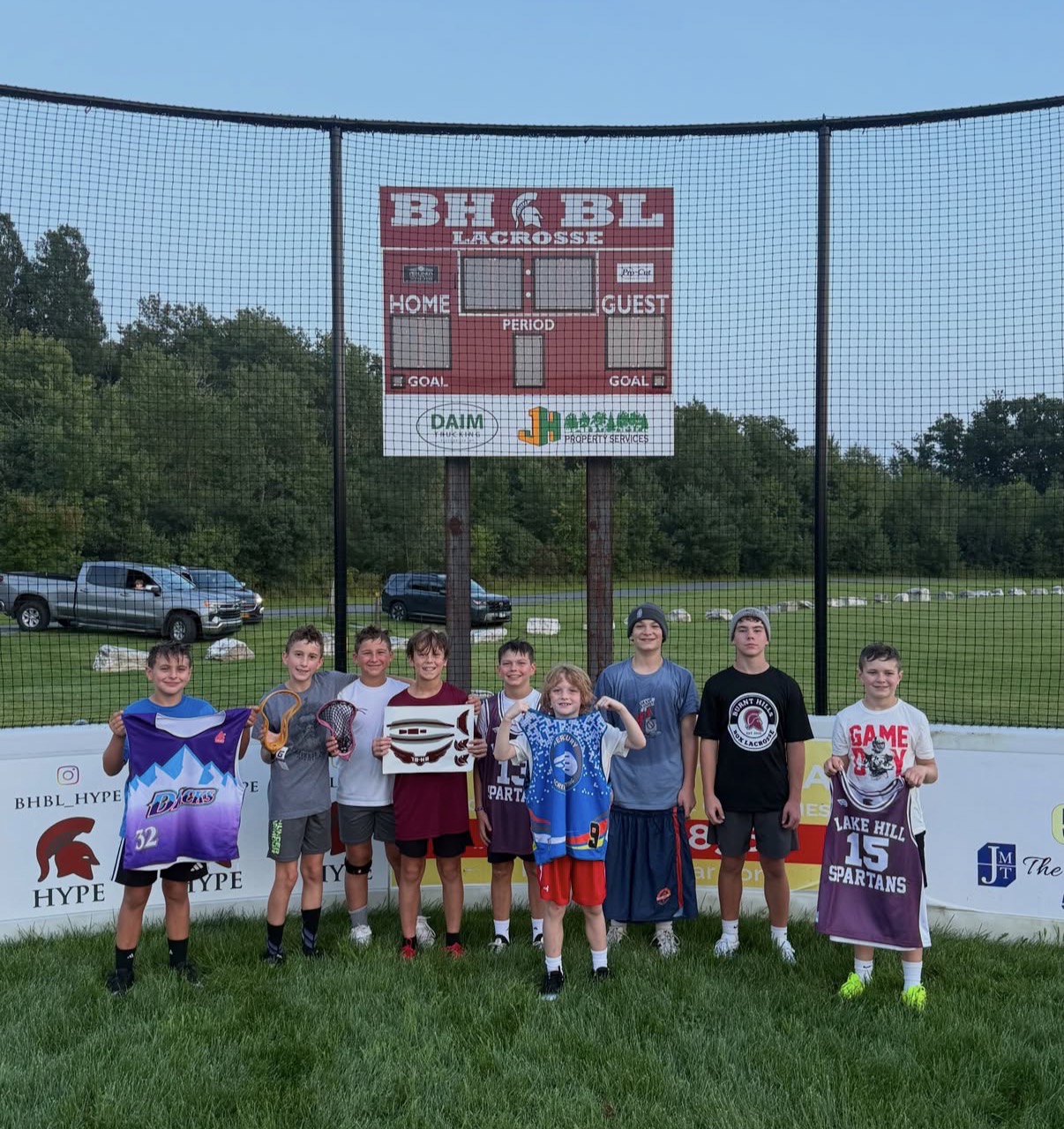 Players displaying lacrosse jerseys at Trust Lacrosse summer camp